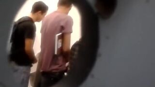 Spying through a small hole in the bathroom on guys masturbating