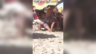 guy caught touching his erect cock on the beach