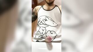 Muscular tattooed dude with a huge cock shooting a load in the bathroom sink