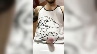 Muscular tattooed dude with a huge cock shooting a load in the bathroom sink