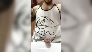 Muscular tattooed dude with a huge cock shooting a load in the bathroom sink