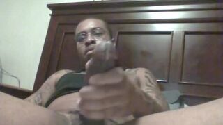 Tattooed nerdy black massaging his fat cock