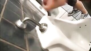Horny guys jerking off in a public restroom