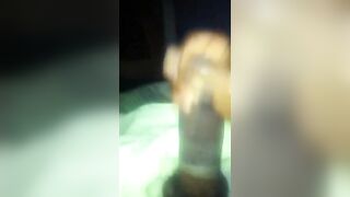 black strokes his huge fat cock with the condom on