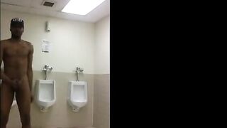 Horny black guy masturbating in the urinals of a public restroom of a restaurant
