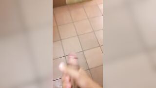 Young black guy spitting out a huge amount of cum in a public toilet