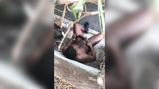 Muscular black guy rubbing his cock completely naked in his back yard