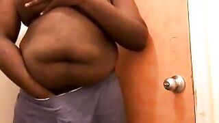 Big chubby black guy rubbing his fat uncut cock