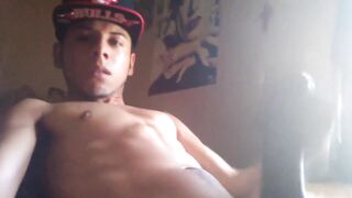 Young latin thug rubbing his long cock and balls