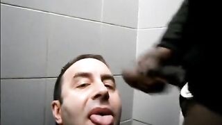 White guy sucks a black guy cock in a public toilet