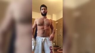 Cute muscular bearded guy doing a solo in front of the web cam