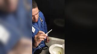 Horny cop masturbating in public toilet while watching porn on his phone