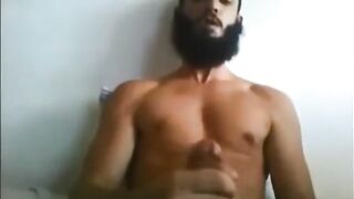 Arab with a long beard strokes his cock solo