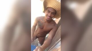 Horny brazilian dude strokes his cock on the beach