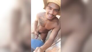Horny brazilian dude strokes his cock on the beach
