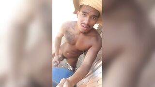 Horny brazilian dude strokes his cock on the beach