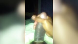 Nigga stroking his cock with a condom on